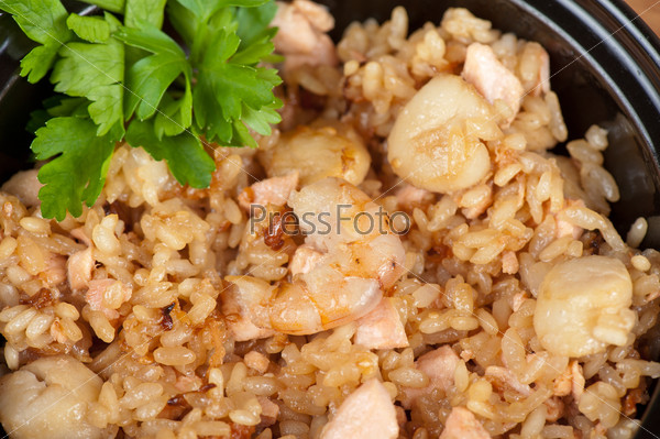 Shrimps risotto garnished with fresh parsley, stock photo