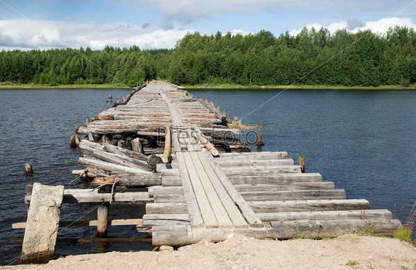 An old broken bridge on a river in Karelia, Russia
