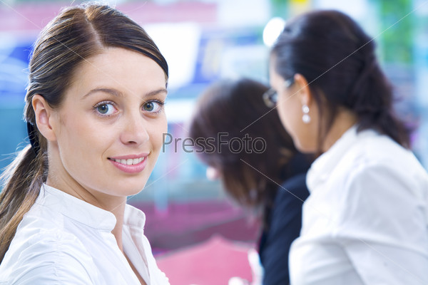 Portrait of young pretty woman in business environment