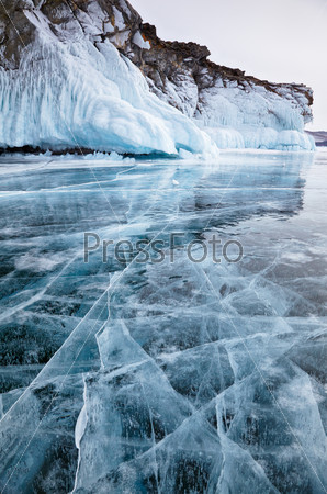 Rocks frozen into the ice of siberian Baikal Lake in winter