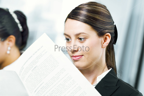 Portrait of young pretty woman getting busy in office environment