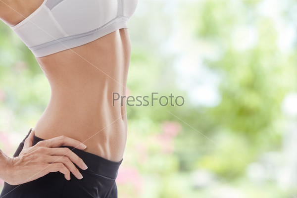 Close up view of well shaped womanÃ¢Â?Â?s body in summer environment