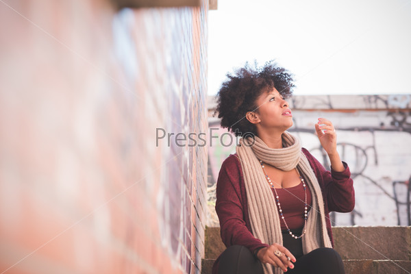 Beautiful black curly hair african woman in town, stock photo