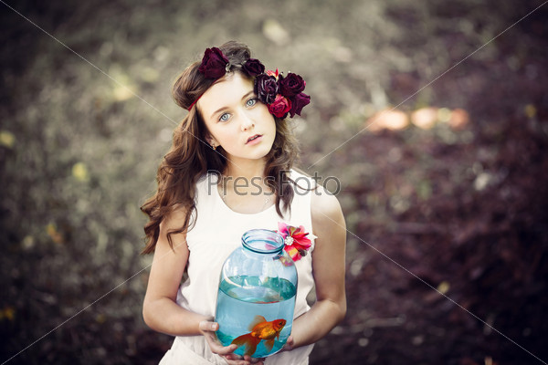 Young beautiful girl with gold fish