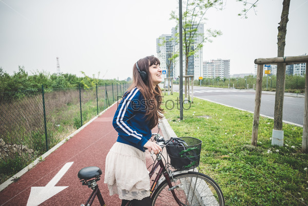 beautiful woman biker cycling in a desolate urban landscape