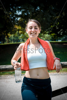 Beautiful woman fitness relaxing after sport at the park, stock photo