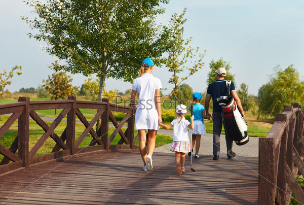 Happy young family in golf country club