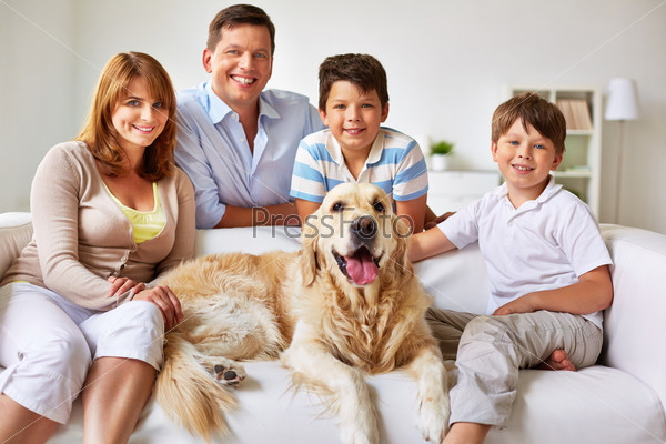 Happy couple, their two sons and dog