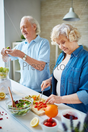Senior husband and wife cooking together
