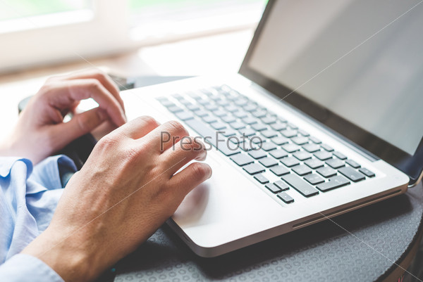 Close up hands multitasking man using laptop connecting wifi, stock photo