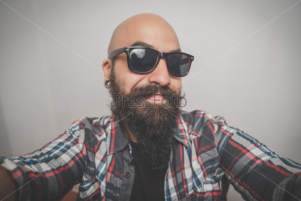 hipster long bearded and mustache man with shirt squares selfie