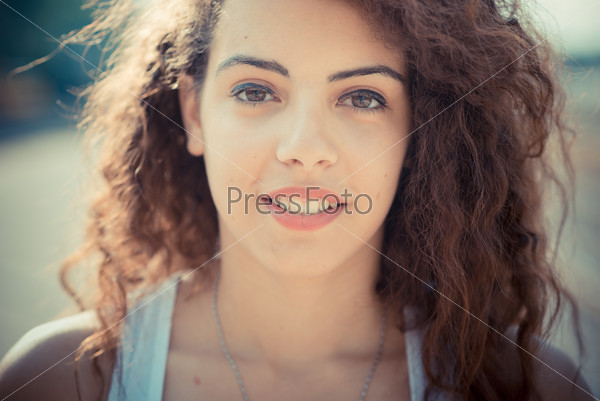 young beautiful long curly hair hipster woman in the city