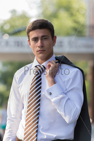 Portrait of an handsome businessman standing in an urban environment
