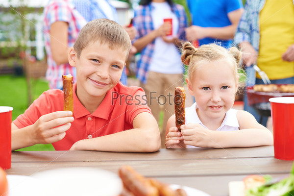 Enjoying barbecued sausages