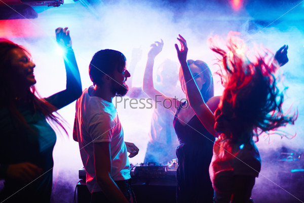 Young people dancing in nightclub, stock photo