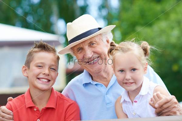 Portrait of a happy senior man with grandchildren