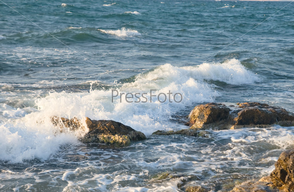 Sea wave rolling on the coast rocks