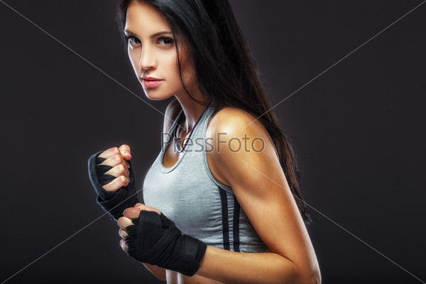 beautiful woman boxer portrait over dark background