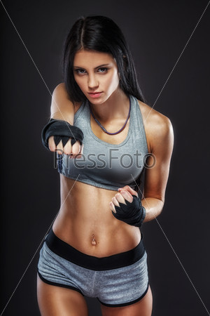 beautiful woman boxer portrait over dark background