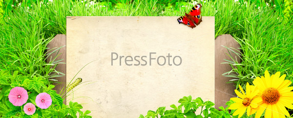 Summer background with paper, old wooden fence and green grass