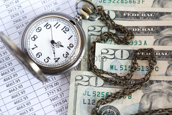 Time is money. Closeup of dollar bank notes near open pocket watch on paper list with digits