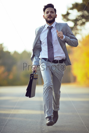Businessman running in park