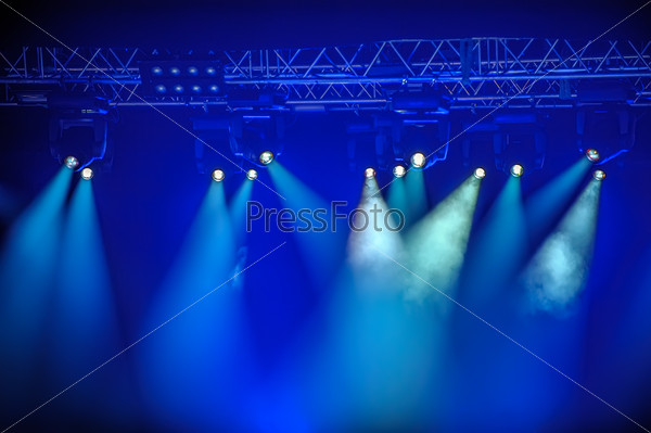 Blue stage spotlights hanging on lighting pipe systems