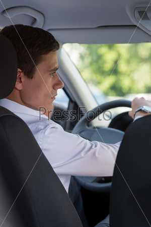 The young man behind the wheel driving car