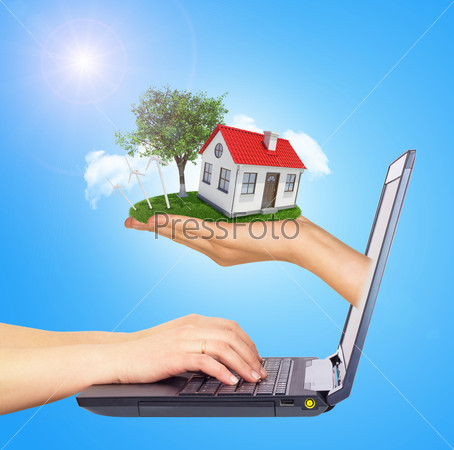 White shack in hand with red roof, brown door and chimney of screen laptop. Hands typing on keyboard. Hands typing on keyboard. Background sun shines brightly on left. Blue sky
