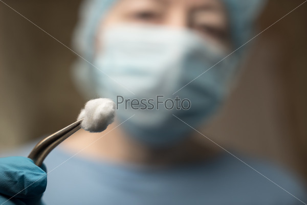 Female dentist with tools staring at a patient