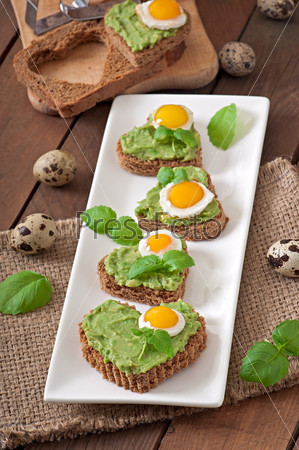 Sandwich with avocado paste and egg in the shape of heart