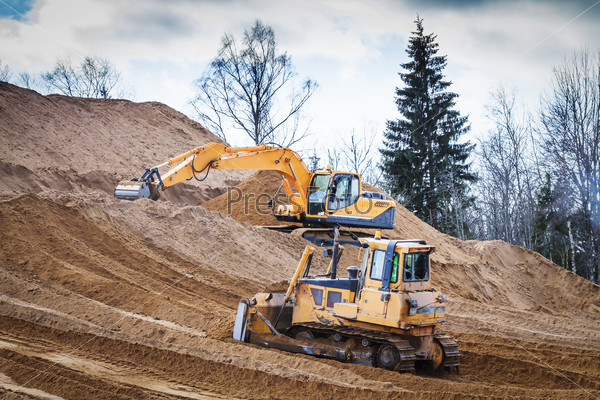 Yellow Excavator and bulldozer at Work in forest