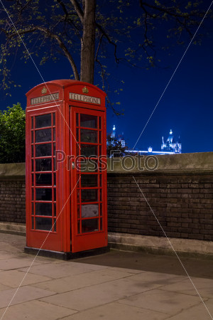 Red telephone and Tower Bridge at night, London, England