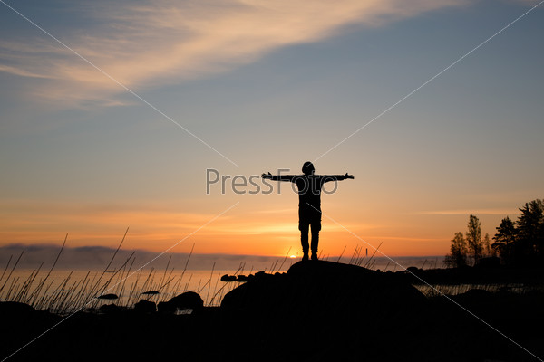 Silhouette of man on a background of sunrise