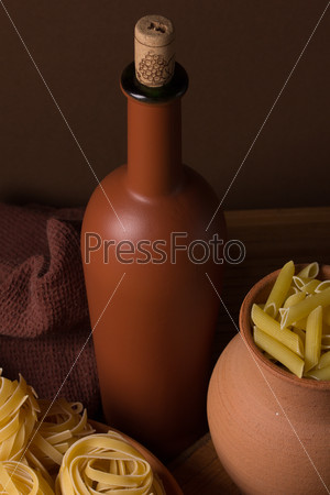 Still life with pasta and ceramic ware in brown tones