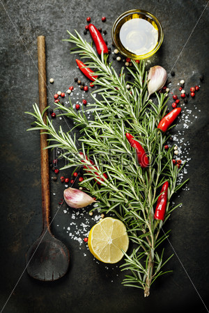 Bunch of spices  and old spoon on dark vintage background. Cooking, vegetarian food or health concept.