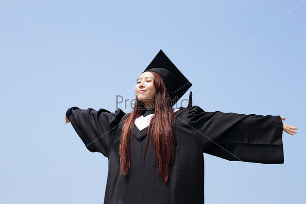 happy graduate student girl hug future and feel carefree look up to copy space, she wear graduation cap and gown ,asian