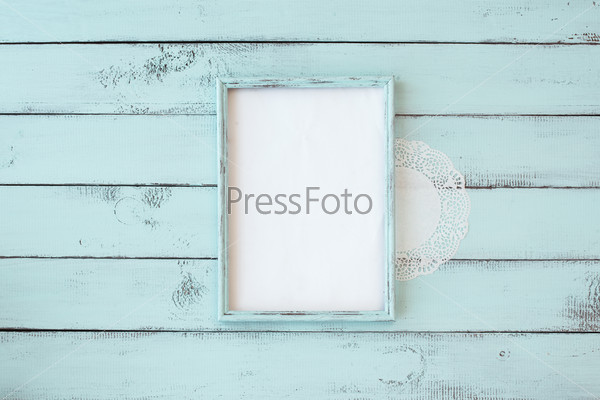 Wooden photo frame on mint shabby chic background