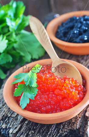 black and red caviar in bowls and on a table