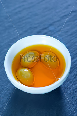 olive oil in bowl and on a table