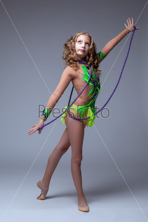 Focused on performance gymnast dancing with rope