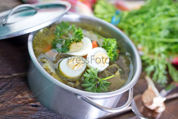 fresh soup with boiled eggon a table