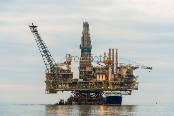 Oil rig platform in the calm sea, stock photo