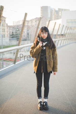 young beautiful asian hipster woman in the city - with fake eyeglasses