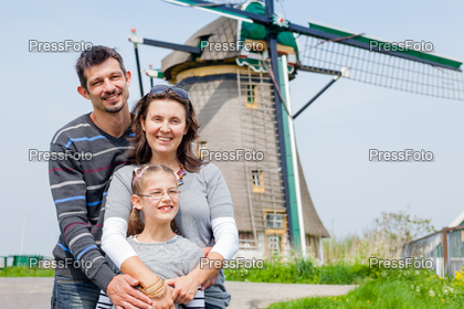 Family of three near windmill in Holland