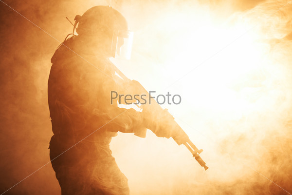 Russian special forces operator in bulletproof helmet in the smoke and fire