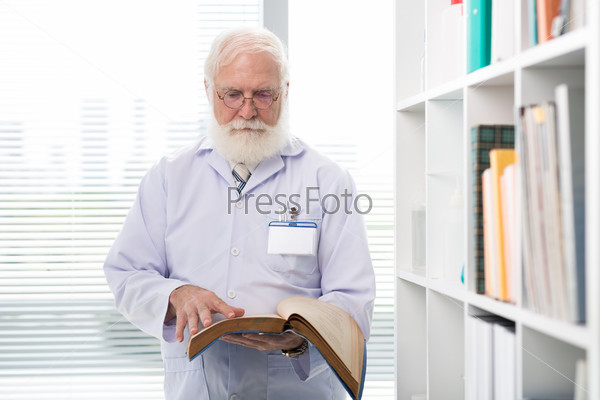 Senior doctor of scientist reading a book in the office
