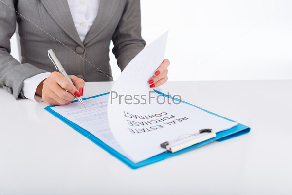 Cropped image of business lady signing real estate purchase contract