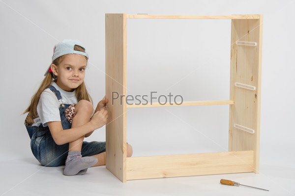 Girl collects garbage furniture chest of drawers