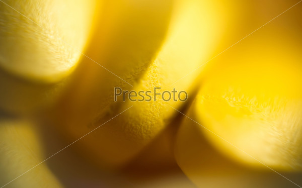 Macro of yellow pills, abstract defocused background.